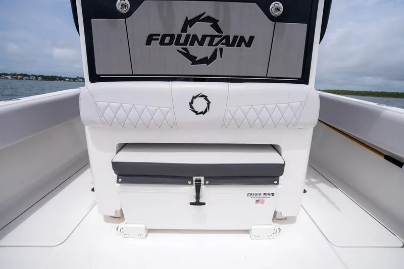 Slide: The Image of 2024 Fountain Bluewater 34 Tournament Edition boat interior with cushioned seating and storage. - 45
