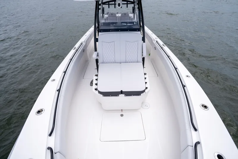 Slide: The Image of 2024 Fountain Bluewater 34 Tournament Edition boat interior with cushioned seating on water. - 46