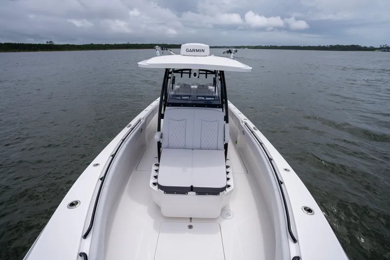 Slide: The Image of 2024 Fountain Bluewater 34 Tournament Edition boat on calm waters, featuring Garmin equipment. - 47