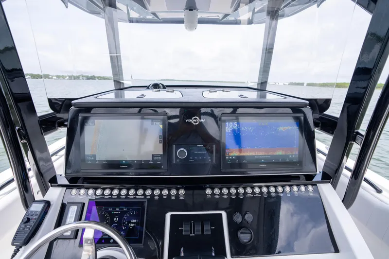 Slide: The Image of 2024 Fountain Bluewater 34 Tournament Edition boat dashboard with advanced navigation displays. - 49