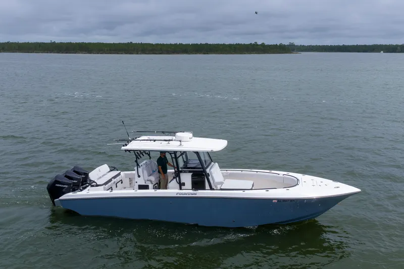 The Image of 2024 Fountain Bluewater 34 Tournament Edition boat cruising on a calm lake. - 5