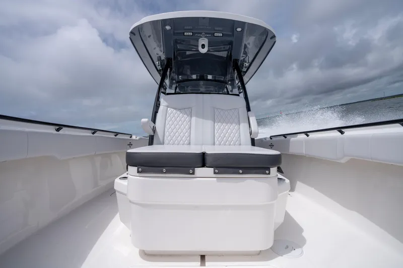 Slide: The Image of 2024 Fountain Bluewater 34 Tournament Edition boat interior with cushioned seating. - 53