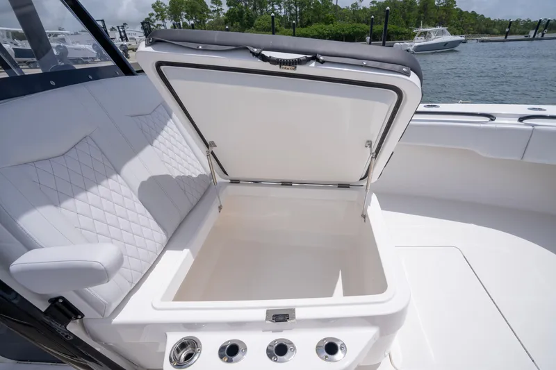 Slide: The Image of 2024 Fountain Bluewater 34 Tournament Edition boat with open storage compartment. - 55