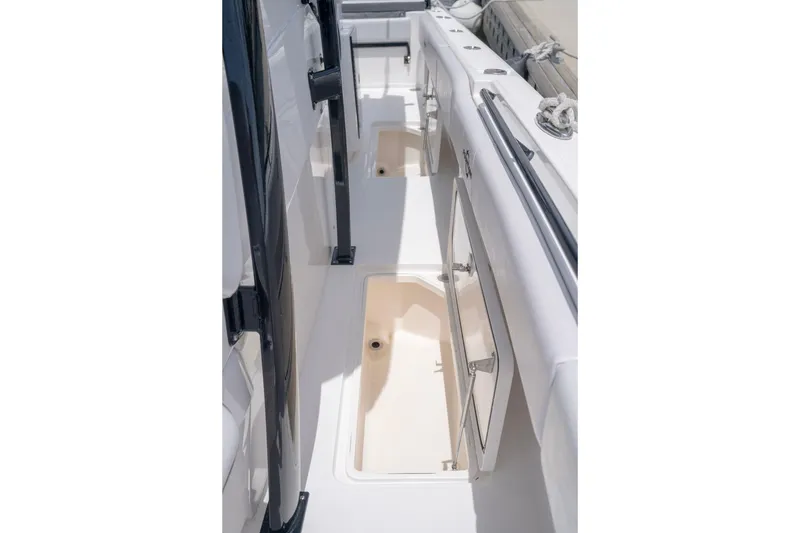 Slide: The Image of 2024 Fountain Bluewater 34 Tournament Edition boat deck with open storage compartments. - 57