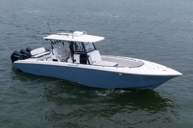 Slide: The Image of 2024 Fountain Bluewater 34 Tournament Edition boat cruising on open water. - 6