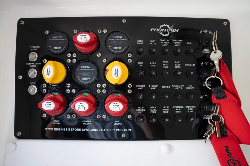 Slide: The Image of Control panel of 2024 Fountain Bluewater 34 Tournament Edition boat with switches and keys. - 61