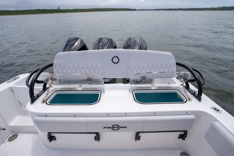 Slide: The Image of 2024 Fountain Bluewater 34 Tournament Edition boat with dual livewells and triple engines. - 62