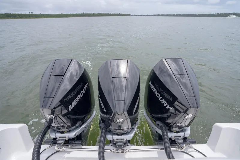 Slide: The Image of Triple Mercury outboard engines on a 2024 Fountain Bluewater 34 Tournament Edition boat. - 63