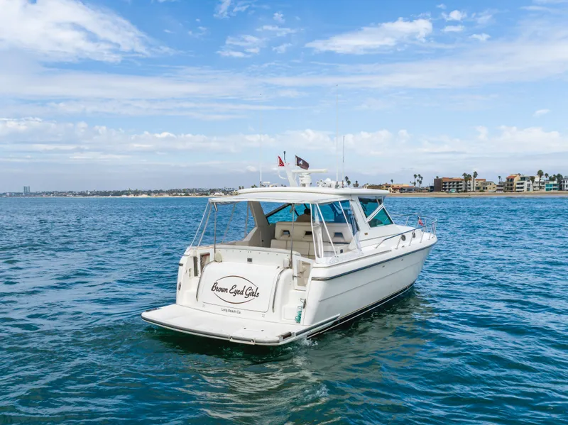 Slide: The Image of 2004 Tiara Yachts 4000 cruising on the ocean near the coast. - 10