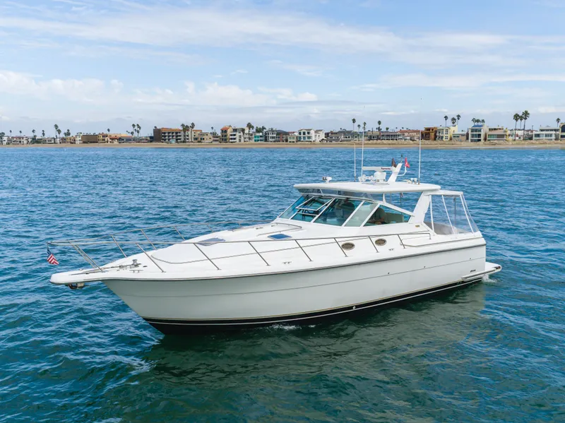 Slide: The Image of 2004 Tiara Yachts 4000 on calm waters near coastline. - 13