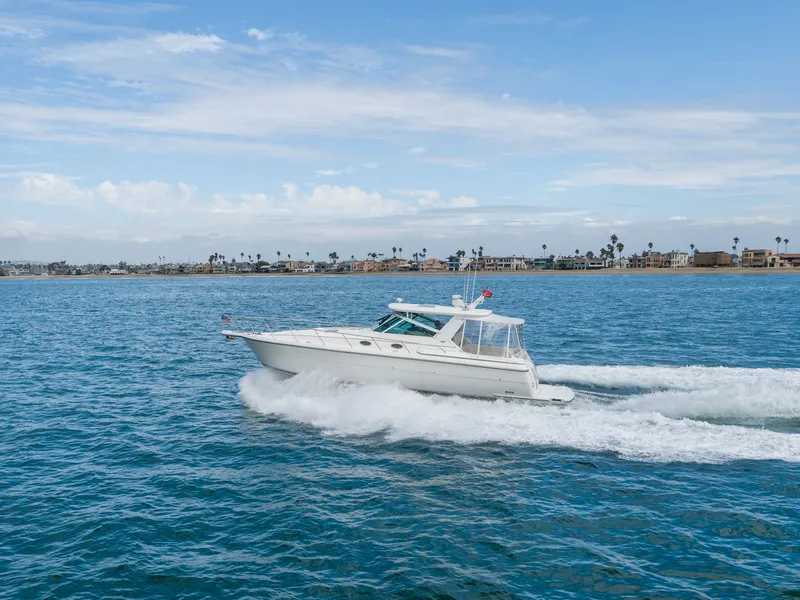 Slide: The Image of 2004 Tiara Yachts 4000 cruising on open sea under clear skies. - 16