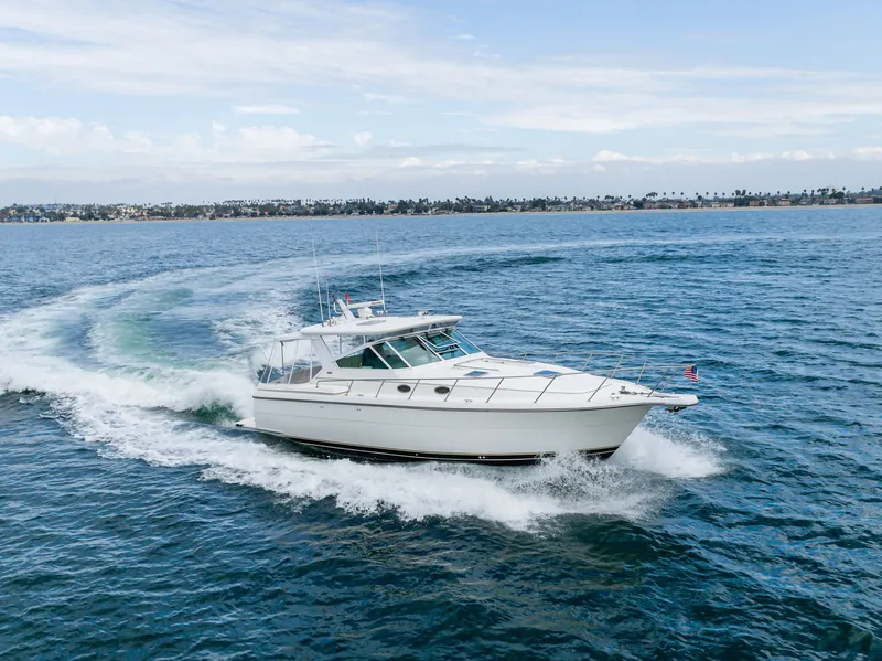 Slide: The Image of 2004 Tiara Yachts 4000 cruising on open sea, white yacht in motion. - 21