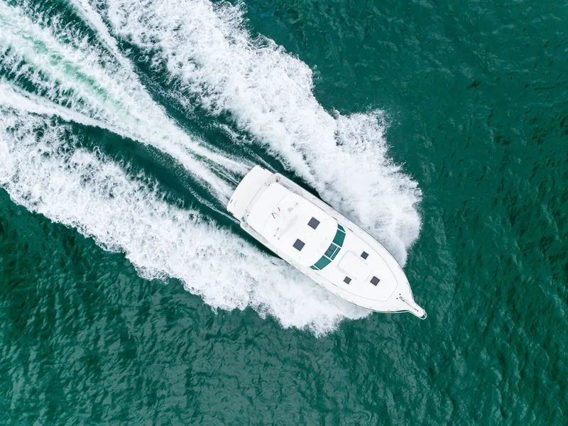 Slide: The Image of Aerial view of a 2004 Tiara Yachts 4000 cruising on water. - 26