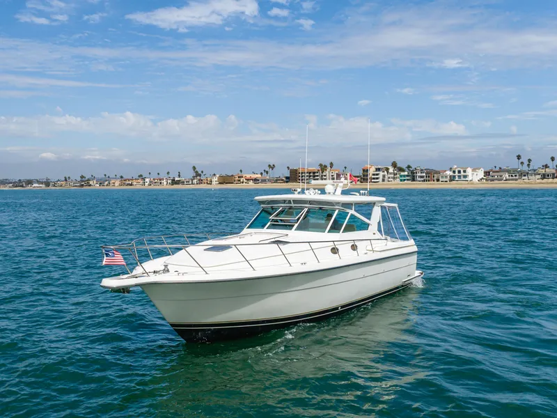 Slide: The Image of 2004 Tiara Yachts 4000 on open sea near coastline. - 6