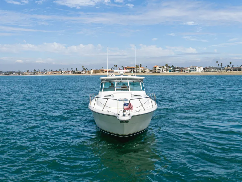 Slide: The Image of 2004 Tiara Yachts 4000 on open water near coastline. - 7