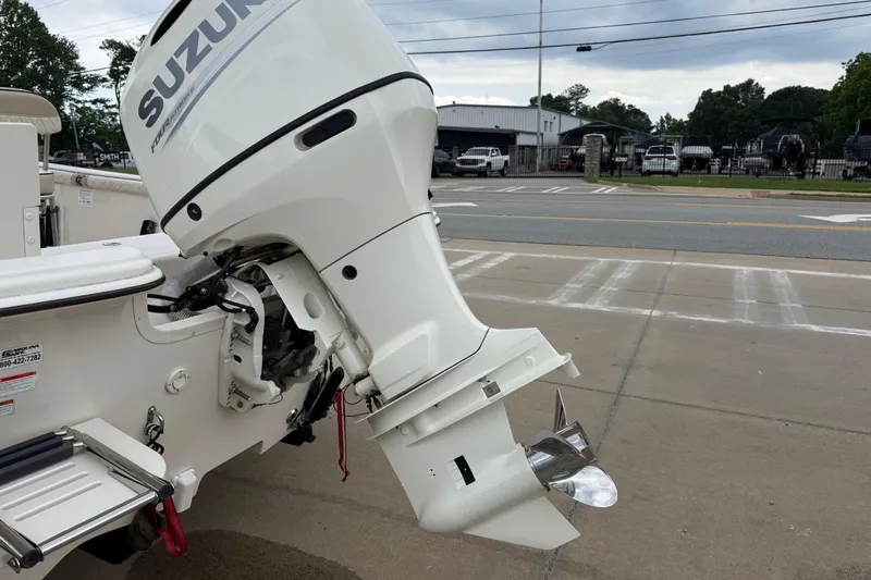Slide: The Image of 2020 Carolina Skiff 21 LS with Suzuki outboard motor, parked on pavement. - 32