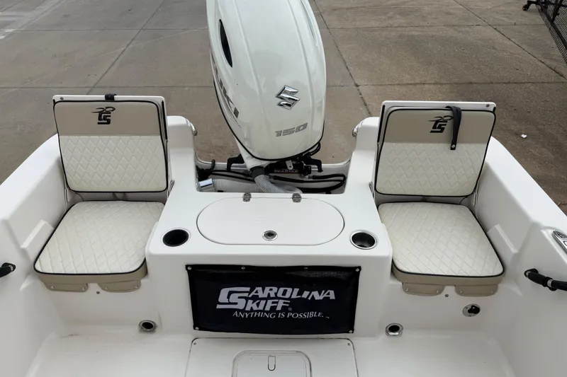 Slide: The Image of 2020 Carolina Skiff 21 LS boat interior with Suzuki outboard motor and cushioned seating. - 38
