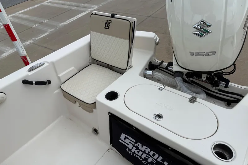 Slide: The Image of 2020 Carolina Skiff 21 LS boat with Suzuki 150 engine, featuring cushioned seating. - 40