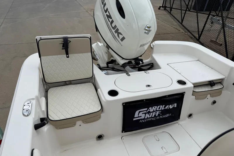 Slide: The Image of 2020 Carolina Skiff 21 LS boat with Suzuki outboard motor and seating area. - 43