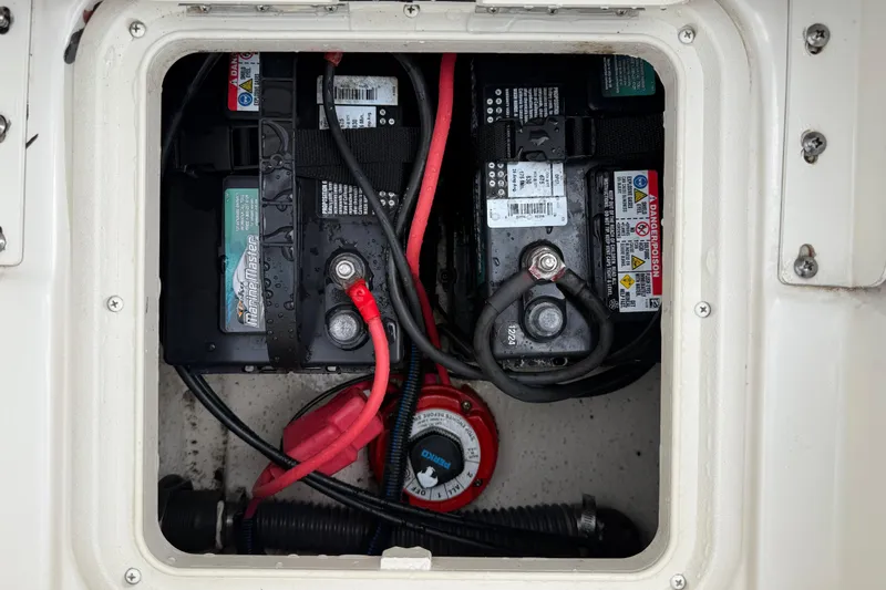Slide: The Image of Battery compartment of a 2020 Carolina Skiff 21 LS boat with wiring and connections. - 44