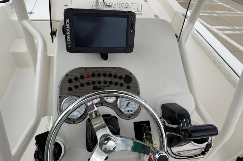 Slide: The Image of 2020 Carolina Skiff 21 LS boat dashboard with steering wheel and Lowrance navigation system. - 47
