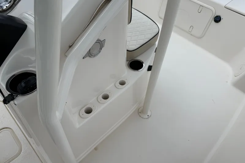 Slide: The Image of Interior of a 2020 Carolina Skiff 21 LS boat, featuring rod holders and seating. - 52