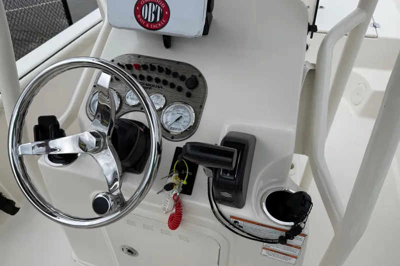 Slide: The Image of 2020 Carolina Skiff 21 LS boat dashboard with steering wheel and control panel. - 54