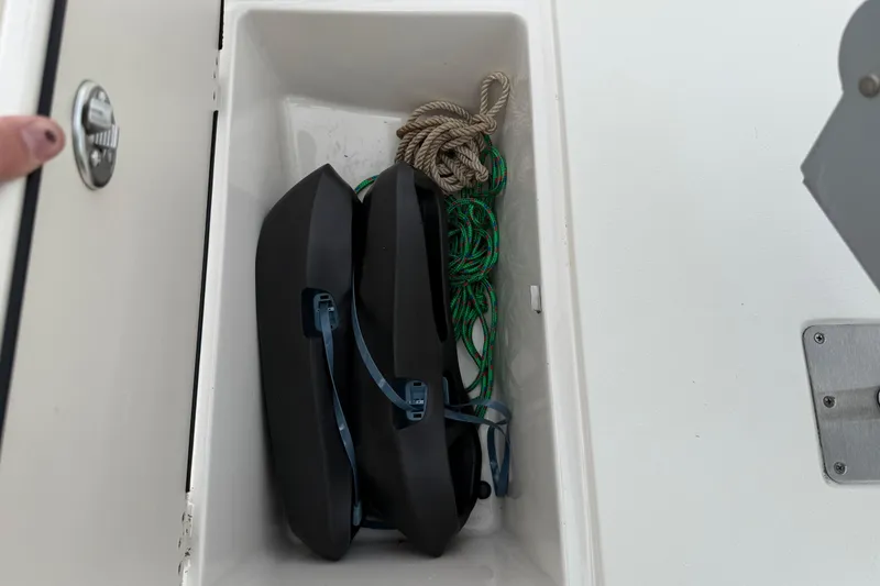 Slide: The Image of Storage compartment in a 2020 Carolina Skiff 21 LS with fenders and ropes. - 58