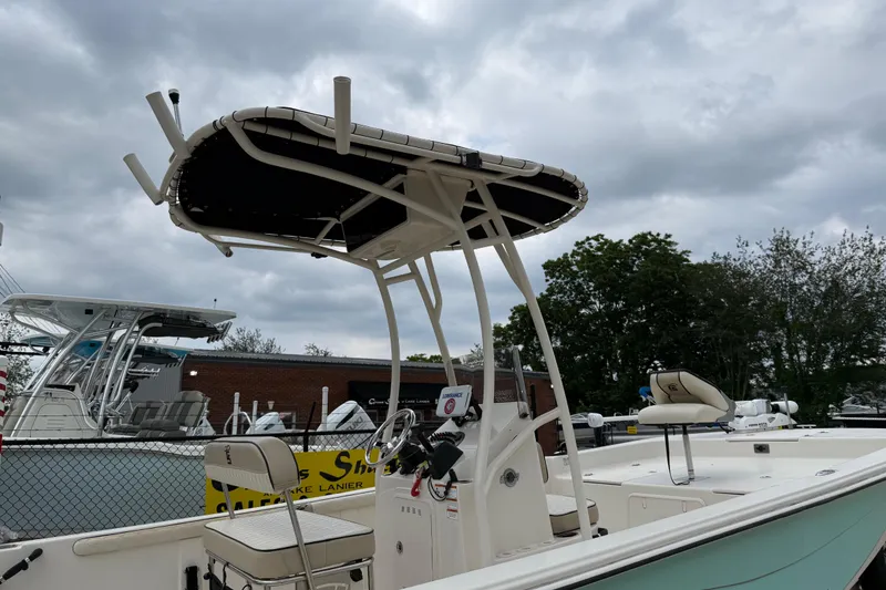 Slide: The Image of 2020 Carolina Skiff 21 LS boat with T-top, parked at a marina under cloudy skies. - 66