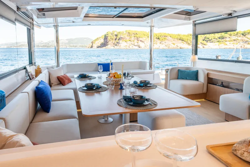 Slide: The Image of Luxurious Bali 5.8 yacht interior with elegant dining area, ocean view, and modern decor, 2026 model. - 3