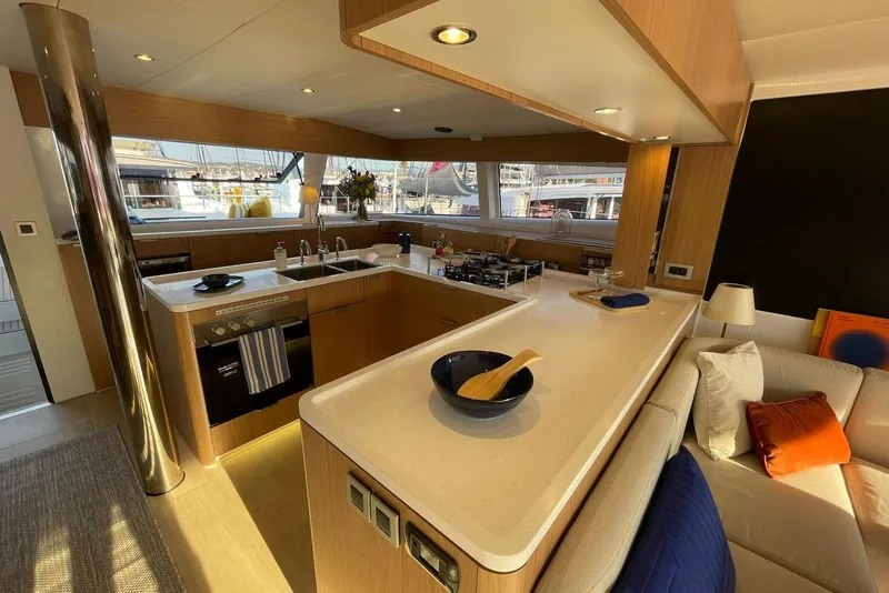 Slide: The Image of Modern kitchen interior on a 2026 Bali 5.8 yacht, featuring sleek countertops and cozy seating. - 8