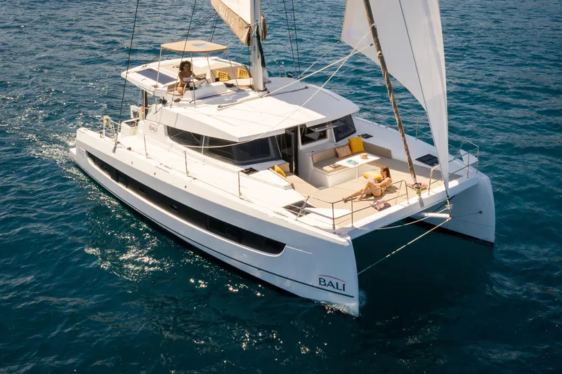 The Image of 2026 Bali 4.2 catamaran sailing on open sea with people relaxing on deck. - 0