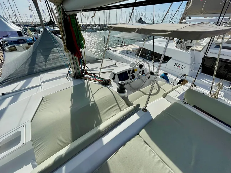 Slide: The Image of 2026 Bali 4.2 yacht deck with helm, sunbeds, and marina view. - 31