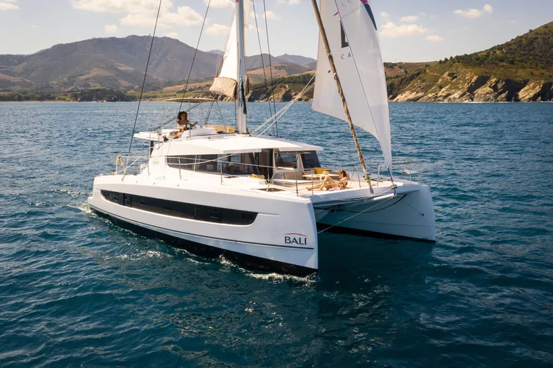 Slide: The Image of 2026 Bali 4.2 catamaran sailing on blue ocean near scenic coastline. - 46