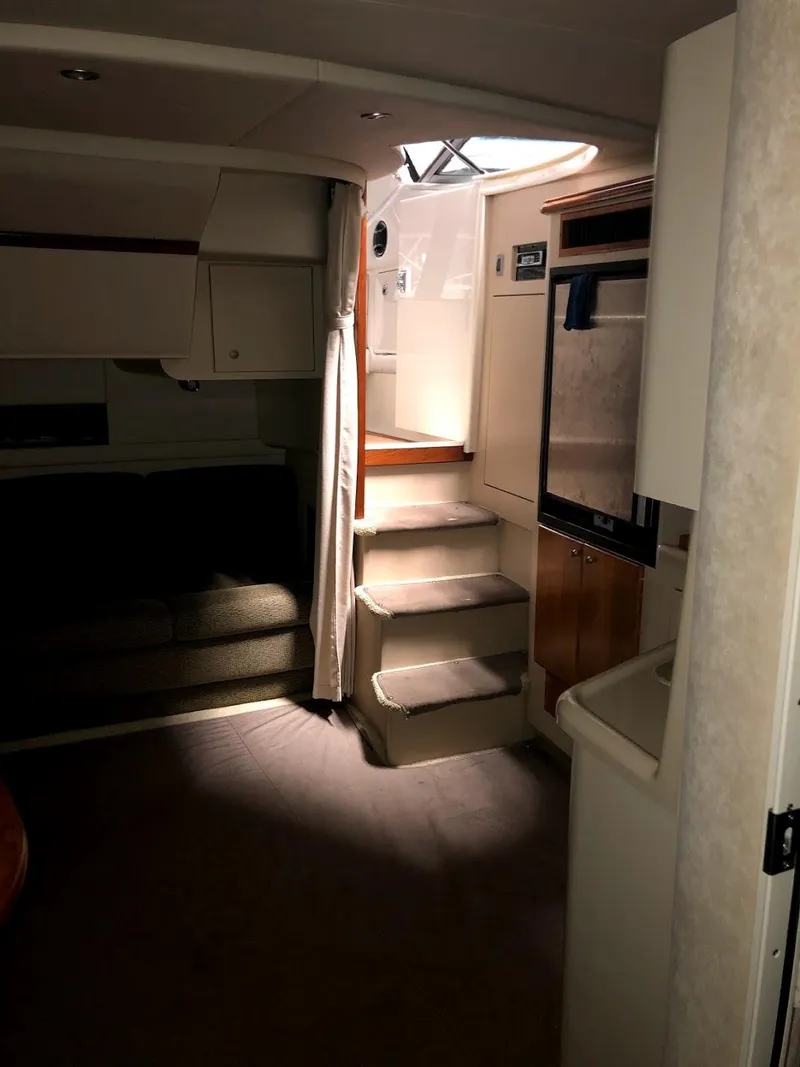 Slide: The Image of Interior of 2000 Cruisers Yachts 3575 Express with stairs and seating area. - 22