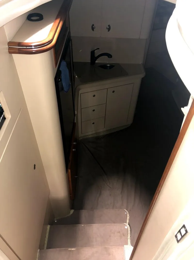 Slide: The Image of Interior of 2000 Cruisers Yachts 3575 Express with kitchenette and stairs. - 23