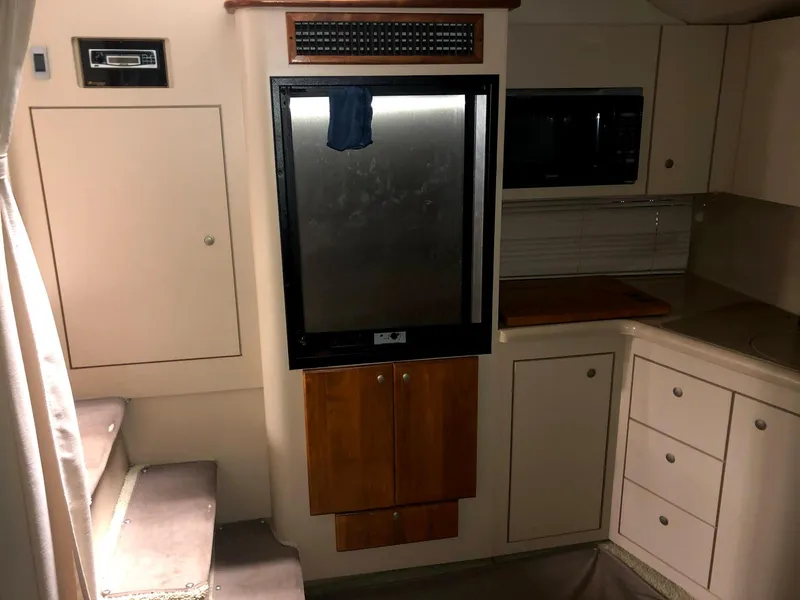 Slide: The Image of Interior of 2000 Cruisers Yachts 3575 Express with kitchen and stairs. - 24