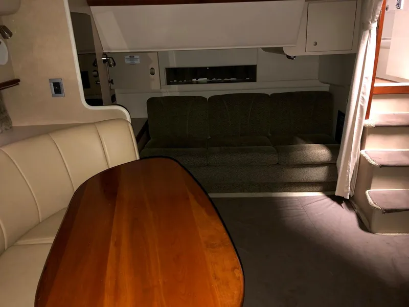 Slide: The Image of Interior of a 2000 Cruisers Yachts 3575 Express with sofa and dining table. - 25