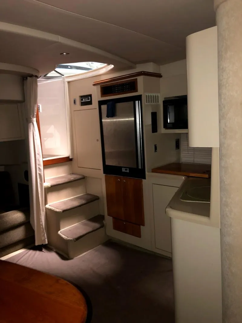 Slide: The Image of Interior of 2000 Cruisers Yachts 3575 Express with stairs and kitchenette. - 28