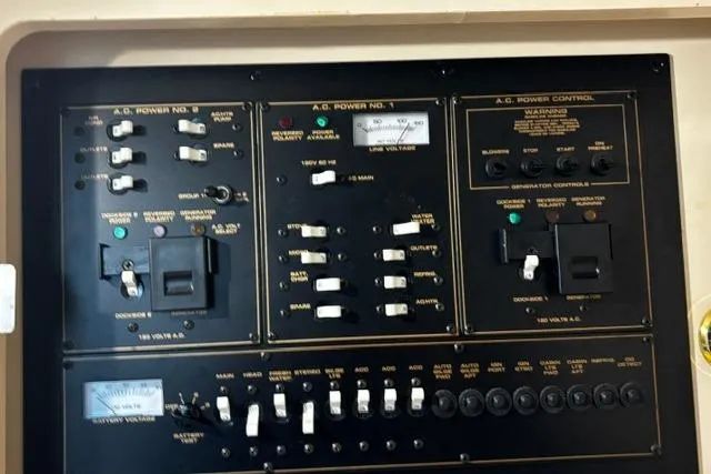 Slide: The Image of Control panel of a 2000 Cruisers Yachts 3575 Express, featuring switches and gauges. - 35