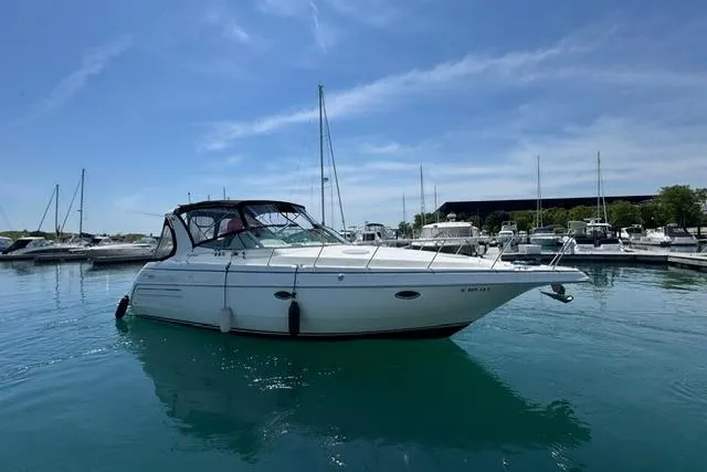Slide: The Image of 2000 Cruisers Yachts 3575 Express in marina, calm water, clear sky. - 39