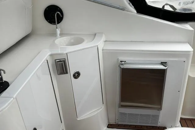 Slide: The Image of 2000 Cruisers Yachts 3575 Express interior with sink and mini fridge. - 6