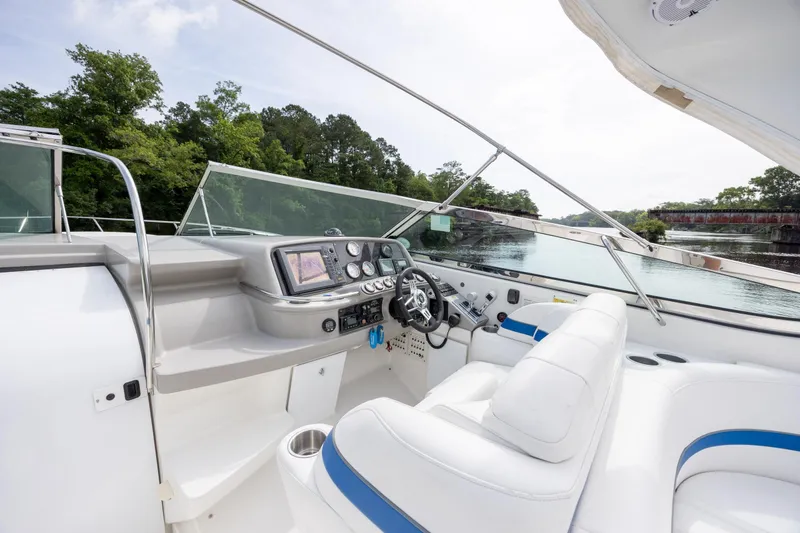 Slide: The Image of 2003 Formula 400 Super Sport yacht cockpit with modern controls and white seating. - 10