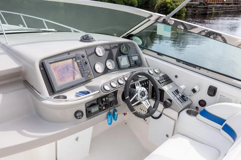 Slide: The Image of Cockpit of 2003 Formula 400 Super Sport boat with navigation instruments and steering wheel. - 11