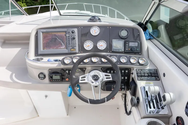 Slide: The Image of Dashboard of a 2003 Formula 400 Super Sport boat with navigation instruments and controls. - 12