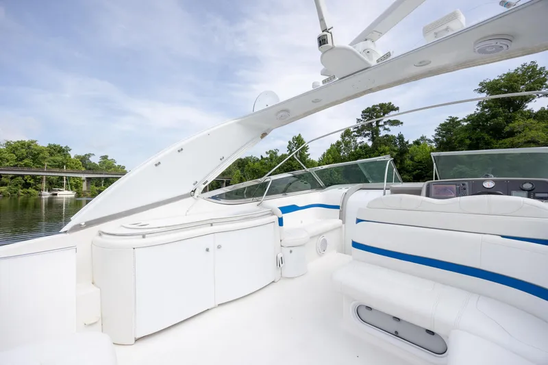 Slide: The Image of 2003 Formula 400 Super Sport boat interior with white seating and blue accents on a sunny day. - 15