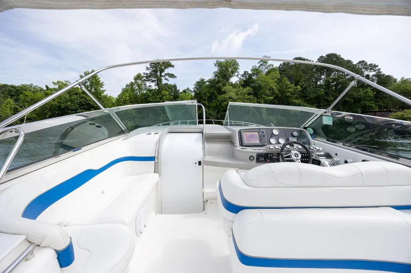 Slide: The Image of 2003 Formula 400 Super Sport boat interior with white seating and modern dashboard. - 16