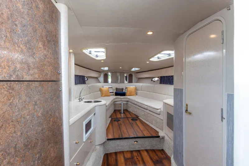 Slide: The Image of Interior of 2003 Formula 400 Super Sport yacht with modern seating and kitchenette. - 17