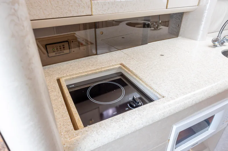 Slide: The Image of 2003 Formula 400 Super Sport yacht kitchen with induction cooktop and sleek countertop design. - 20