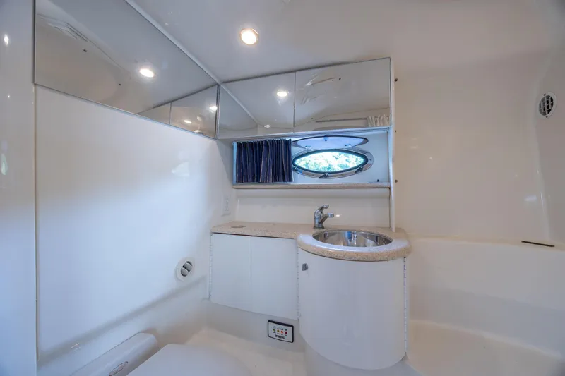 Slide: The Image of 2003 Formula 400 Super Sport yacht bathroom with modern fixtures and oval window. - 24